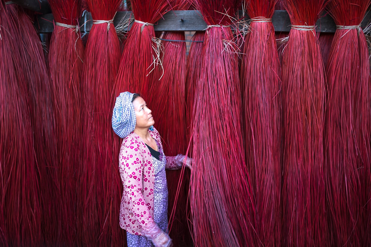 a woman standing in front of a wall of red hair