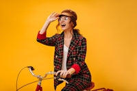 a woman riding a bike with a surprised look on her face