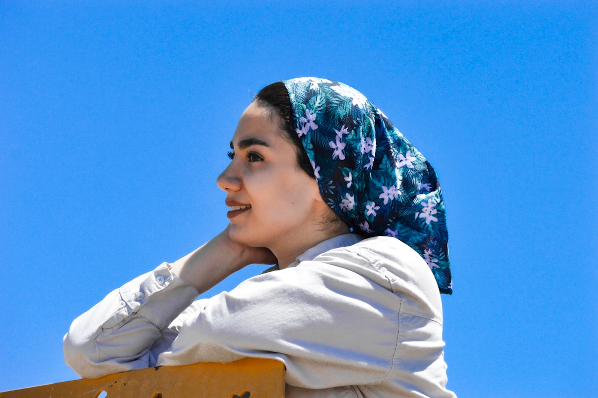 woman in white long sleeve shirt and blue and white floral hijab