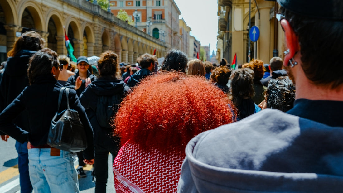a crowd of people walking down a street